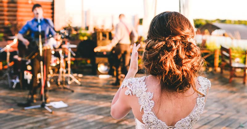 Guitar player performing at a wedding with the bride